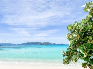 View of beach and ocean with islands in background