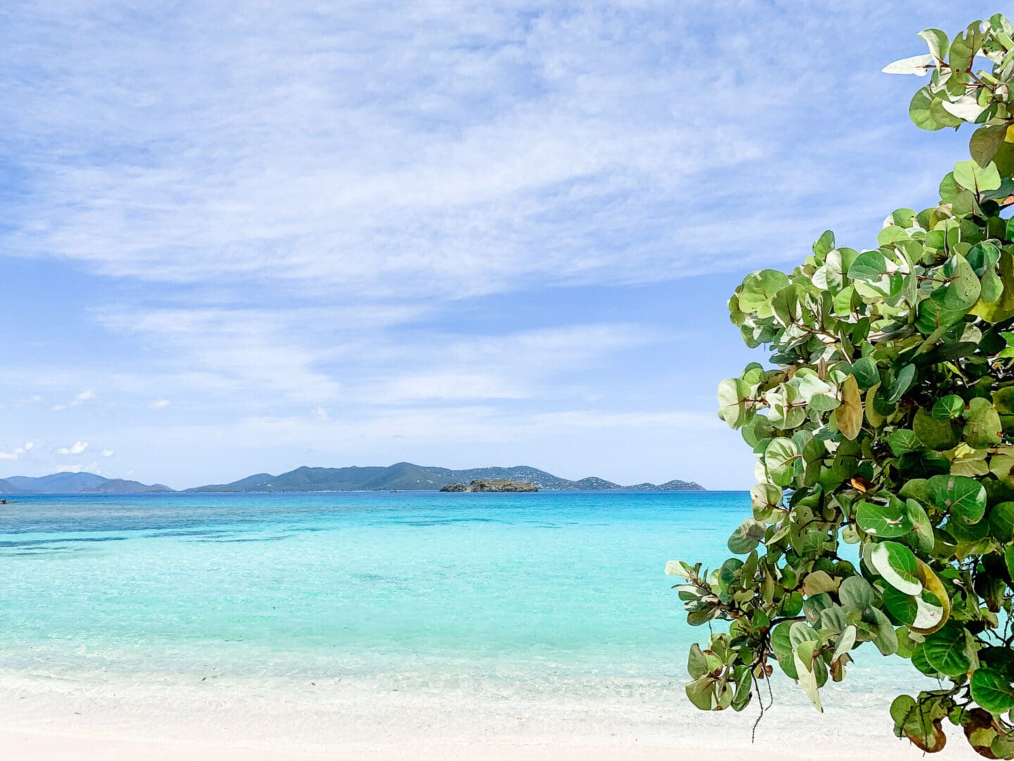 View of beach and ocean with islands in background